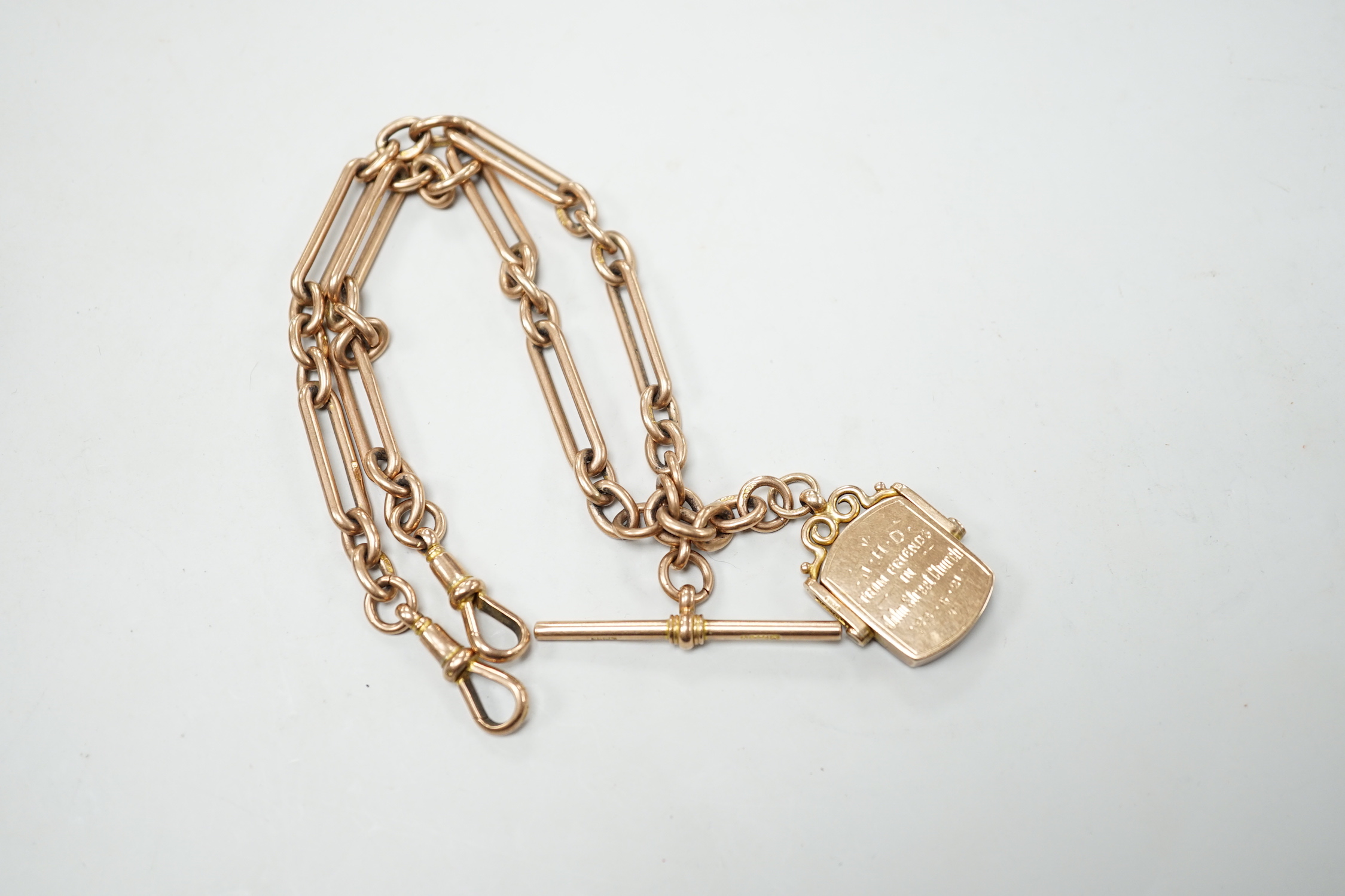 An Edwardian 9ct gold albert, hung with a bloodstone set swivelling fob, 38cm, gross weight 51.1 grams.